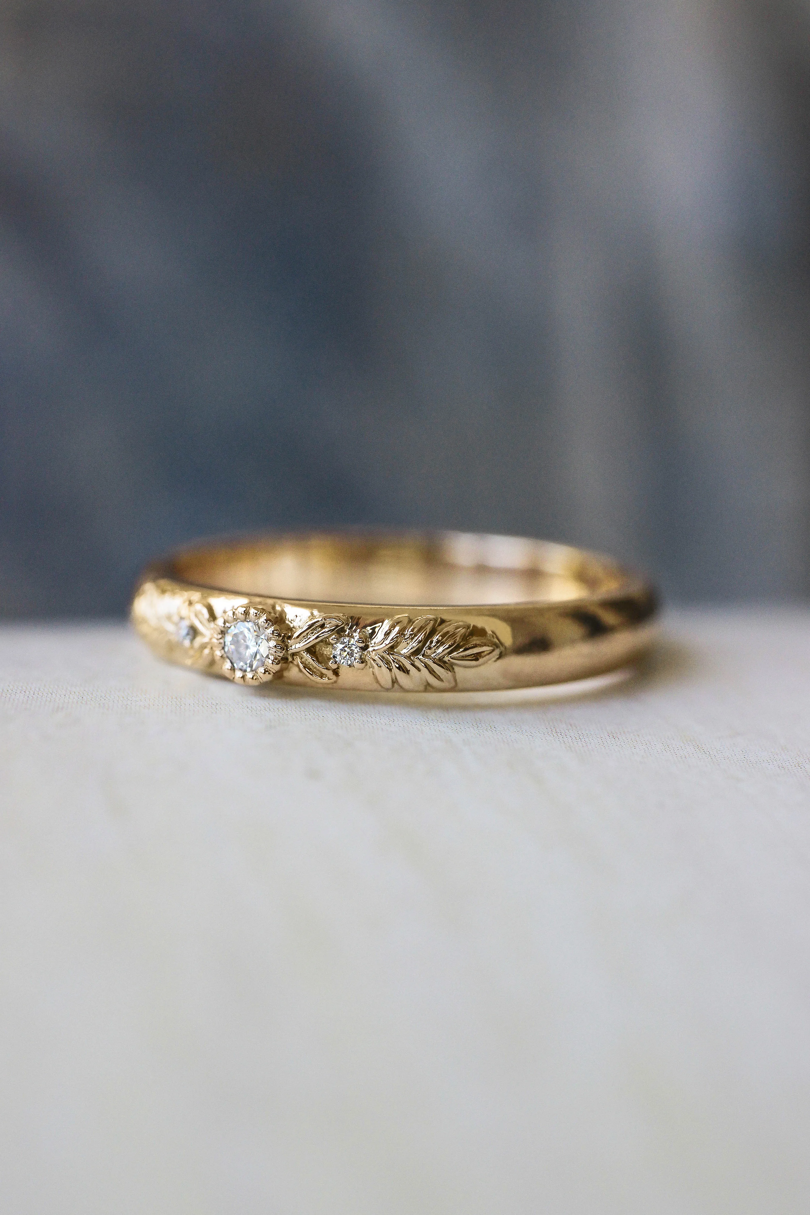Wreath wedding band with three gemstones